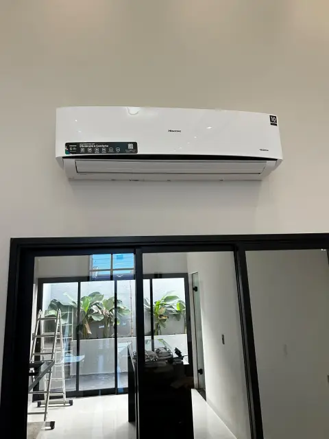 Instalação de ar-condicionado feita pela AF Ar Condicionado: Split Hisense Inverter em ambiente integrado, acima de porta de vidro.